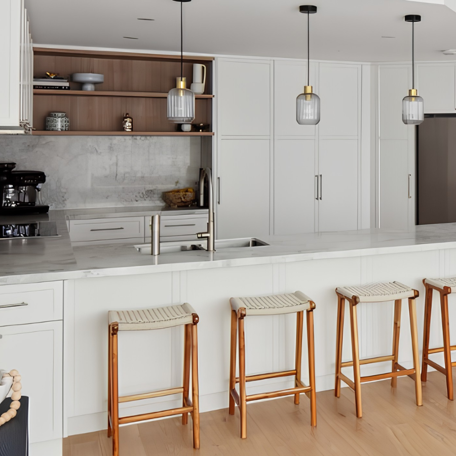 Modern kitchen with white cabinetry, breakfast bar seating and coffee station