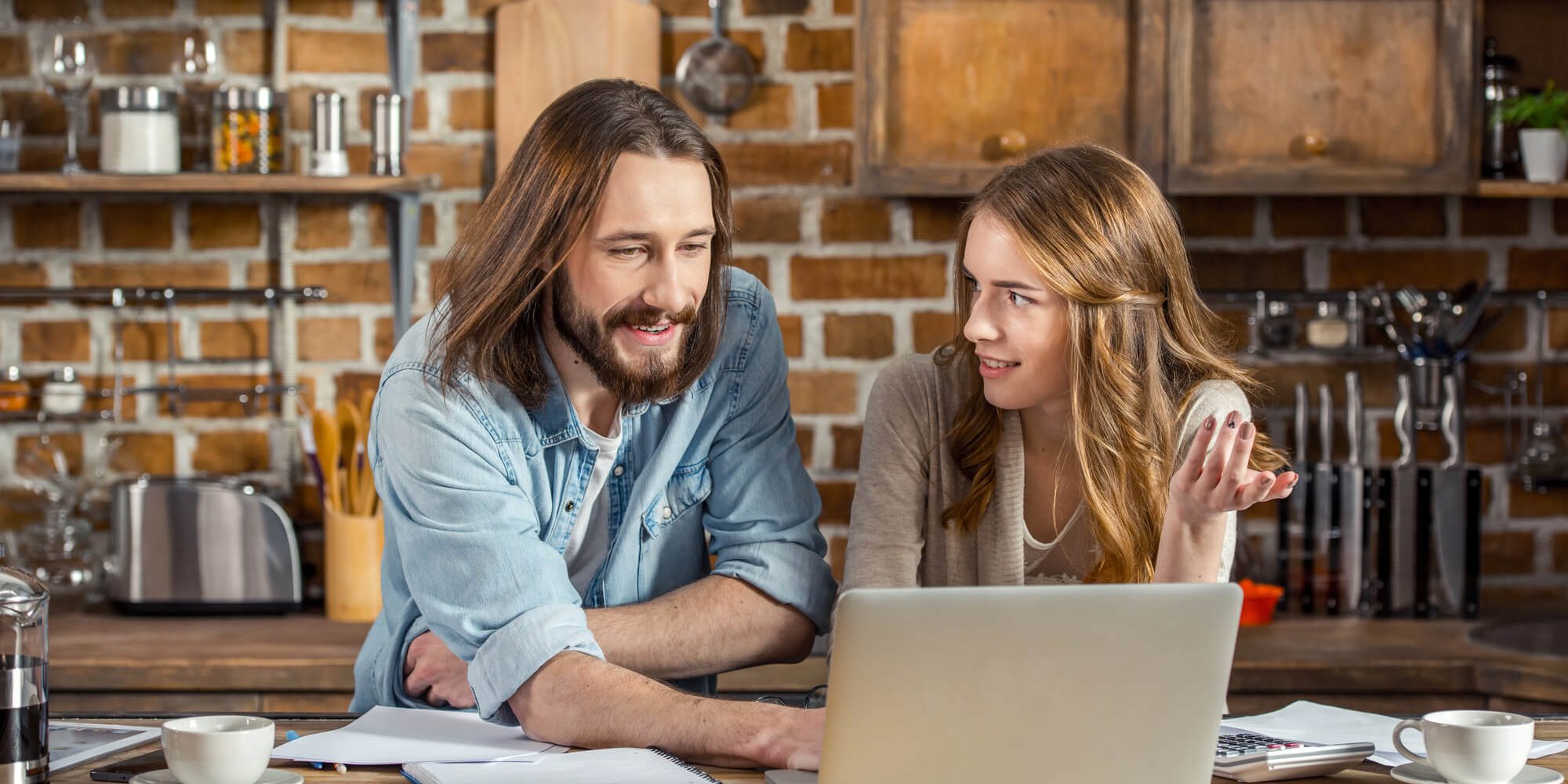 why-perth-homeowners-choose-navigate Why do Perth's homeowners choose our renovation services? - A couple deciding on small kitchen designs on a laptop